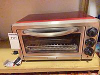 Front view of KitchenAid toaster oven showing glass door, handle and control panel