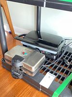 Both appliances together on shelf, cords visible