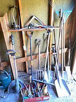 Overall lot showing long-handled tools, YardWorks trimmer, hand tools in crate