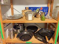 Entire lot on shelving showing variety of cookware items