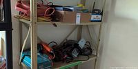 Shelf showing assorted power tools and extension cords