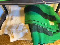 Both folded blankets on shelf