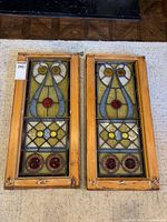 Both stained glass panels side-by-side to show overall design and condition