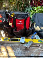 Overall lot showing Husky tote, level, putty knife, tools visible