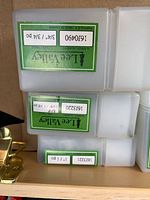 Stack of Lee Valley plastic router-bit cases with part numbers visible