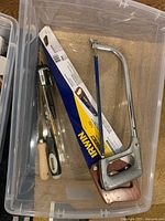 Irwin hand saw, hacksaw frame, chisels in plastic tote
