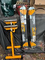 Sawhorses and roller stands collapsed and standing on ground