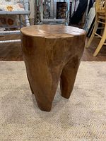 Full view of burl side table showing three-leg design