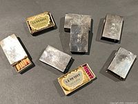 Seven silver matchbox covers with some matchboxes inserted