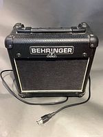 Front view of Behringer AC108 combo amplifier with power cord