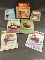 All seven cookbooks arranged with bamboo stand