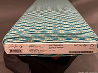 End of fabric bolt showing FreeSpirit, Joel Dewberry True Colors label and geometric print