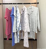 Five garments on clothing rack showing overall assortment