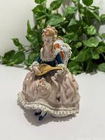 Front view of seated Victorian lady figurine holding mandolin
