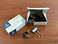 Two Business Source 65364 binder clip boxes, one open showing clips