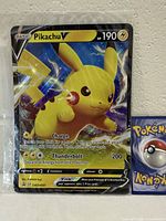 Front view of Pikachu V jumbo card and partial standard card