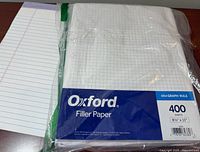 Sealed Oxford graph paper pack next to lined loose-leaf paper
