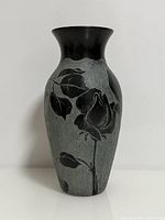 Front view of black stone vase showing etched rose