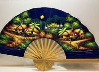 Front view of opened fan showing Thai village painting