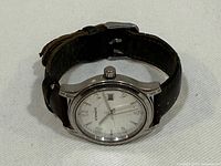 Front angled view of watch showing dial, case and strap