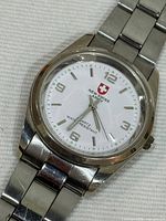 Front view of watch showing dial, hands, bracelet