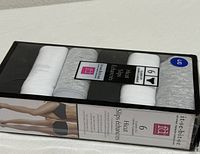 Front of sealed box showing three rolled white and three rolled grey hi-cut slips