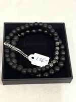 Bracelets inside black box with price tag visible