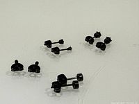 Four pairs of black stud earrings laid out on surface showing overall lot