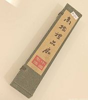 green brocade box closed with Chinese label