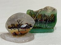 Front view of both painted stones showing artwork and coloration