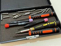 Open case showing screwdrivers and bits in foam insert