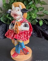 Front view of Russ Berrie cowgirl figurine holding tambourine