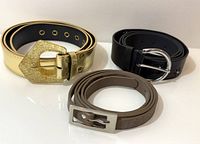Three belts coiled: gold, black, brown