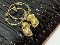 Hoop earrings with acorn charms close-up