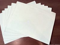 All six cream canvas placemats fanned out
