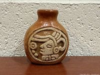 Front view showing Mayan face relief and overall shape