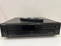 Front view of Sony DVP-C600D with remote on top