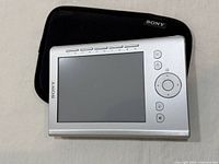Front view of Sony PRS-300 e-reader on top of case