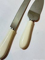 Close-up of white resin handles and stainless blades