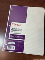 Front of sealed Staples 400-sheet ruled refill paper pack