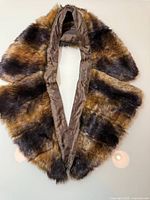 Full view of faux fur collar showing shape, fur colors, and satin lining