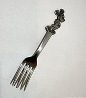 Full view of fork showing Mickey Mouse figure and four tines