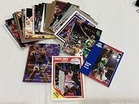 Scattered stack of basketball cards showing front designs and variety