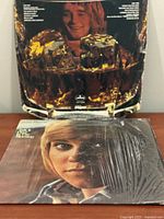 Front covers of both albums showing artwork and shrink wrap