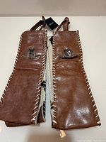 Two brown faux leather wine gift bags side by side