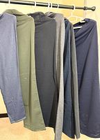 Five pairs of Tuff Athletics pants hanging, showing assorted colours