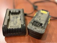 Charger and battery pack front view showing dust and wear