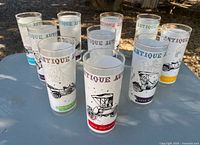 Front view of all 10 Antique Autos highball glasses displayed on a table