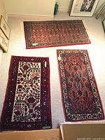 Three rugs laid out on carpeted floor for overall view