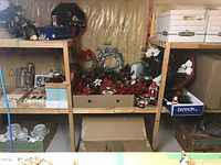 Shelving unit with wreaths, garlands, poinsettias, Danson box and other Christmas decor